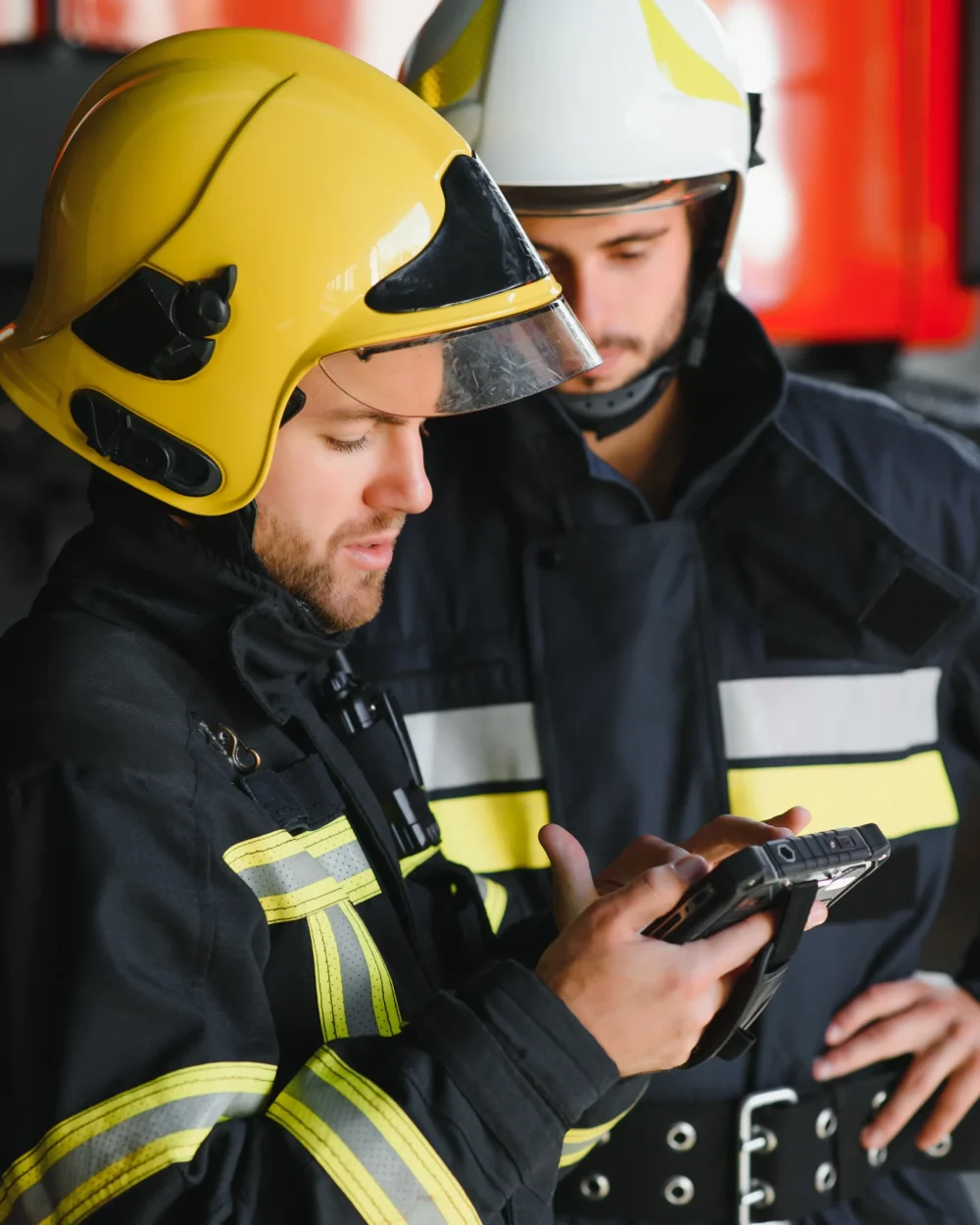 firefighters-using-smart-phone-in-front-of-truck-2026-09-24-09-09-06-utc