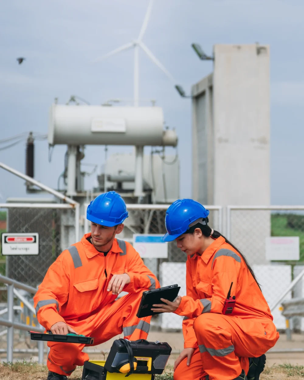 two-engineers-in-orange-uniforms-inspecting-equipm-2026-09-25-04-56-14-utc